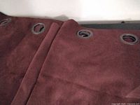 Close view of curtain fabric and grommets