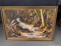Full view of framed woodland stream painting