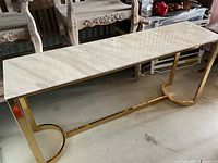 Full view of console table showing marble top and brass base