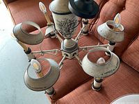 Top view of cream six-arm metal chandelier on couch