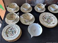 Overview of Coalport china set on table showing cups, saucers, plates and soup bowls
