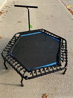 Full view of hexagonal trampoline with handlebar