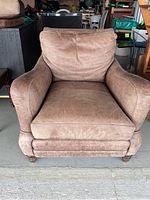 Front view of brown leather armchair showing overall design and condition
