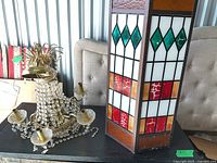 stained glass hanging light and brass chandelier on table