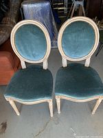Front view of both teal velvet chairs