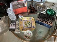 Overall lot view showing all items together on glass table