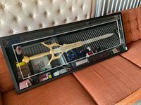 Full view of framed Soul Sword on sofa