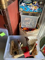 Clear tote with pirate ship parts, fabric bin with Mega Bloks, small bin with action figures, boxed Boeing 747 Airport Playset