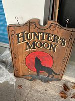Front view of wooden Hunter's Moon sign showing design and overall condition
