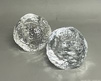 Two Kosta Boda Snowball votive holders angled view