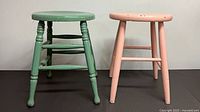 Green and pink stools side by side front view