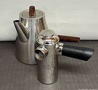 Front view showing both stainless pieces, wood and plastic handles visible