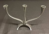 Front view of three-arm candle holder showing overall shape and base.