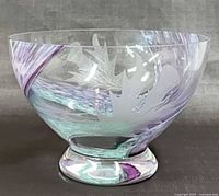 Side view of footed bowl showing etched motifs and color swirls