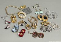 Overview of all jewelry pieces including bracelet, brooches and multiple earring pairs