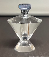 Front view of perfume bottle displaying full shape and stopper