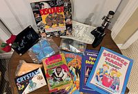 Overall view of microscope, crystal kit materials, books, comic, magazine and puzzle
