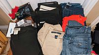 Overview of folded jeans, dress pants, tops