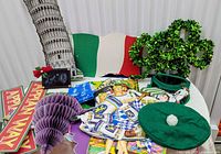 Overview showing Leaning Tower cut-out, Italian flag, shamrock wreath, hats, purple honeycomb grapes and Oktoberfest pieces