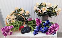 All bouquets arranged with vase and basket on table