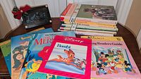 Full lot showing stack of six Learning series books and four Disney storybooks