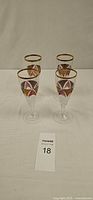 Four Bohemian style crystal champagne flutes standing upright
