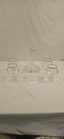 Group shot of four cognac glasses and decanter