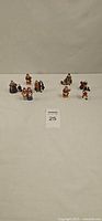All eight Dept 56 porcelain figures displayed