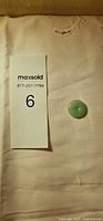 Jade disc next to size reference card