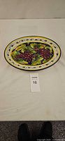Front view of platter showing hand painted grape motif