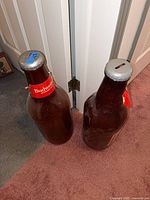 Two 23 in plastic Budweiser bottle banks standing side by side