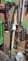 Group of tools including clamps, hacksaw, crowbar, sledgehammer