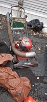 Front view showing Craftsman 4-in-1 vacuum chipper, suction hose, collection bags