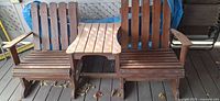 Front view of wooden double Adirondack bench with center table