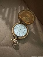 Open watch showing dial, case, missing parts