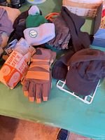 Table view showing gloves, hats, goggles packaging, and organizer
