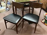 Two of the four matching Stanley dining chairs