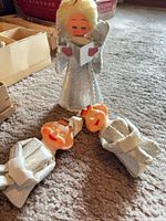 Angel and two elf figurines on carpet