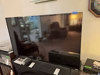 Front view of Vizio TV on stand