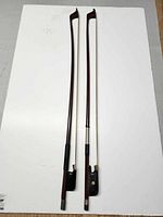 Two cello bows full length view