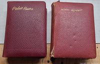 Front covers of both red leather bound books showing gilt names Robert Burns and William Shakespeare