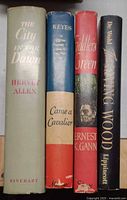Spines of all four hardcover books with dust jackets