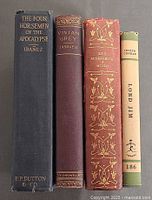 Spine view of all four books standing upright