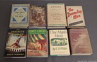 All eight books laid out, dust jackets visible