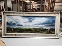 Full view of framed landscape painting