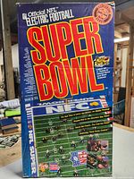 Front view of boxed Official NFL Electric Football Super Bowl game