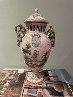 Full view of faience urn showing lid, handles, base