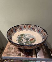 Overall view of Royal Doulton Geneva footed comport on books