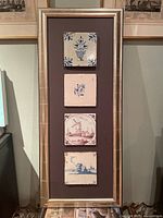 Full view of silver frame holding four Delft tiles