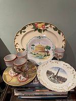 Overall group showing platter, two souvenir plates, four cups, bowl